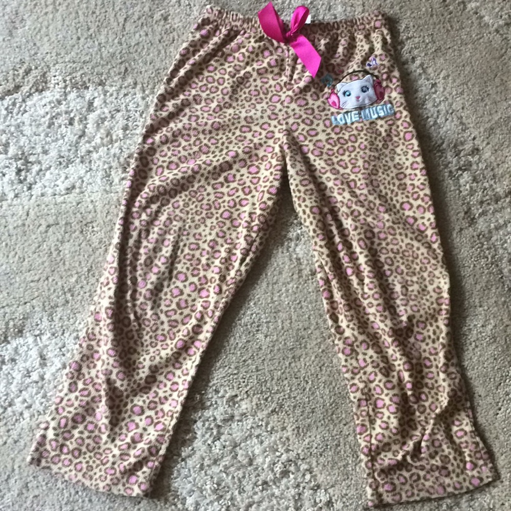 A pair of pants that have a cute cat an them